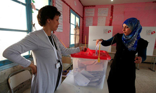 A woman casts her ballot at a polling station during an election in Tunis October 23, 2011. The election, the first free vote in Tunisia's history, will set a standard for other Arab countries where uprisings have triggered political change or governments have tried to rush reforms to stave off unrest. REUTERS/Zohra Bensemra
